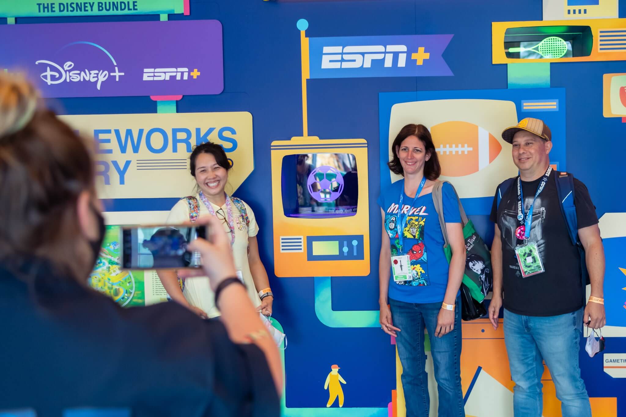 Guests pose in front of the ESPN section of the main wall